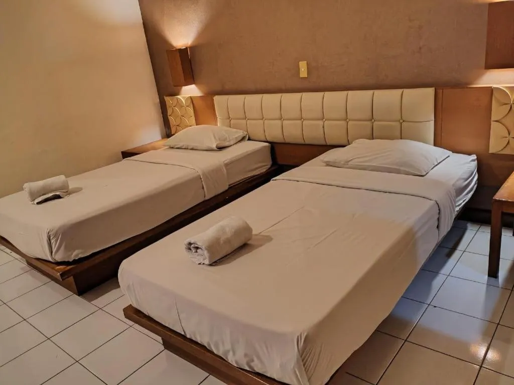 Bed in Nyiur Resort Hotel