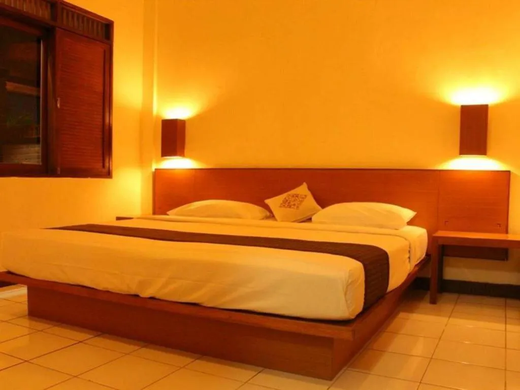 Bed in Nyiur Resort Hotel