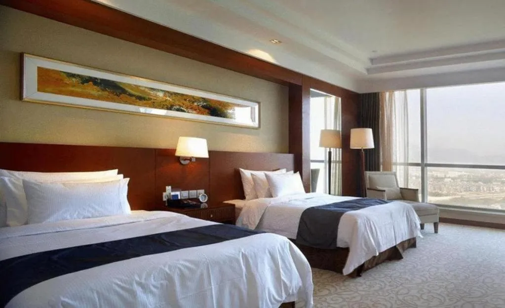Bed in New Century Grand Hotel Ninghai Jinhai