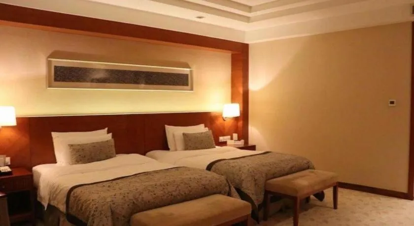 Bed in New Century Grand Hotel Ninghai Jinhai