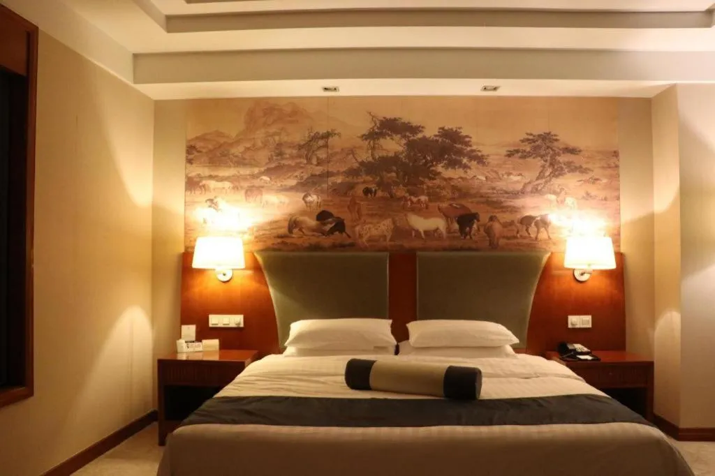 Bed in New Century Grand Hotel Ninghai Jinhai