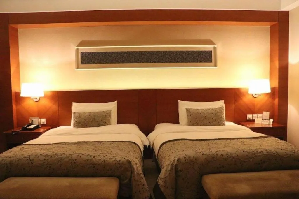 Bed in New Century Grand Hotel Ninghai Jinhai