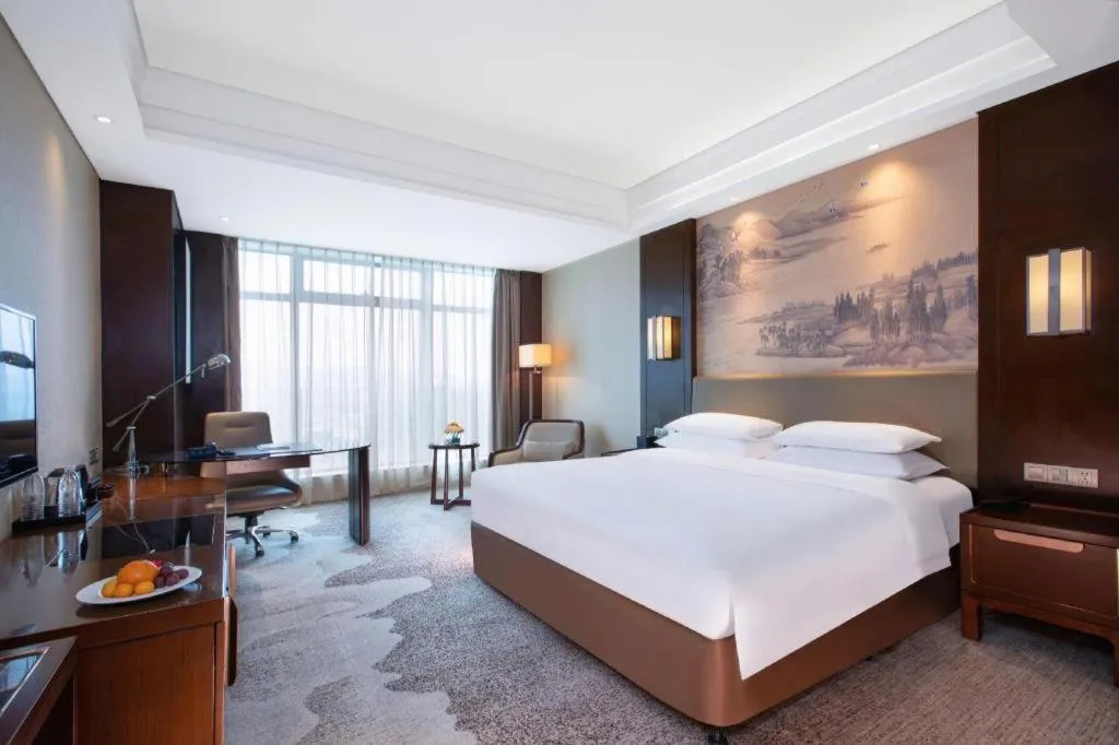Bed in New Century Grand Hotel Hangzhou Fuyang Dongfangmao