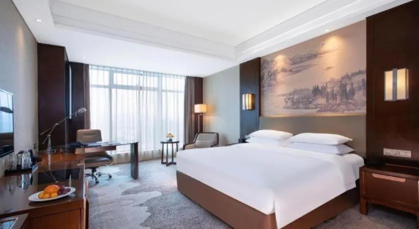 Bed in New Century Grand Hotel Hangzhou Fuyang Dongfangmao
