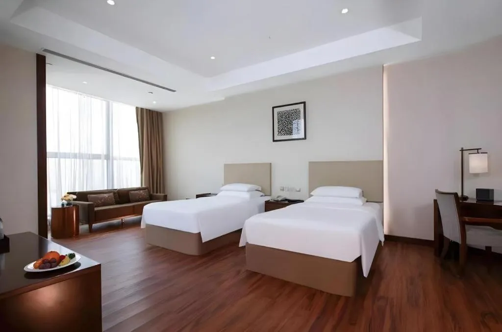 Bed in New Century Grand Hotel Hangzhou Fuyang Dongfangmao