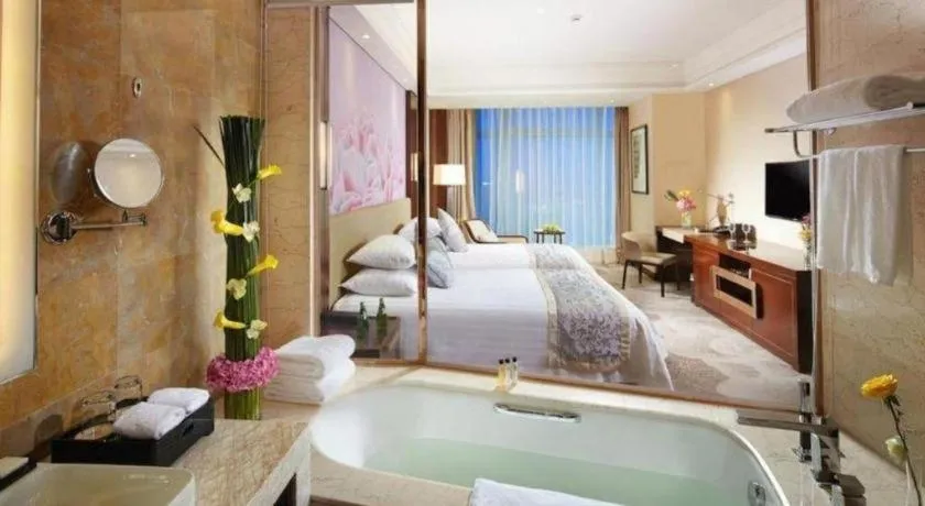 Bed in New Century Grand Hotel Hangzhou Fuyang Dongfangmao