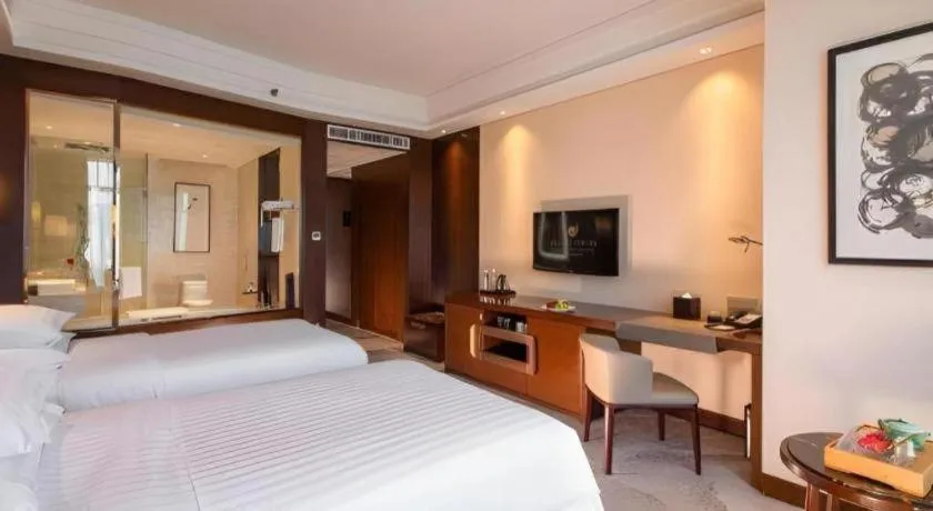 Bed in New Century Grand Hotel Hangzhou Fuyang Dongfangmao