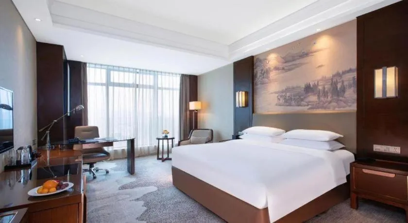 Bed in New Century Grand Hotel Hangzhou Fuyang Dongfangmao