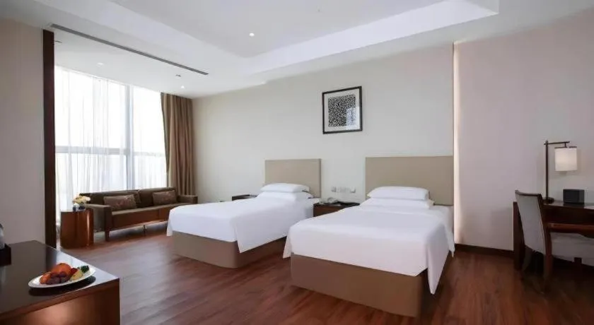 Bed in New Century Grand Hotel Hangzhou Fuyang Dongfangmao