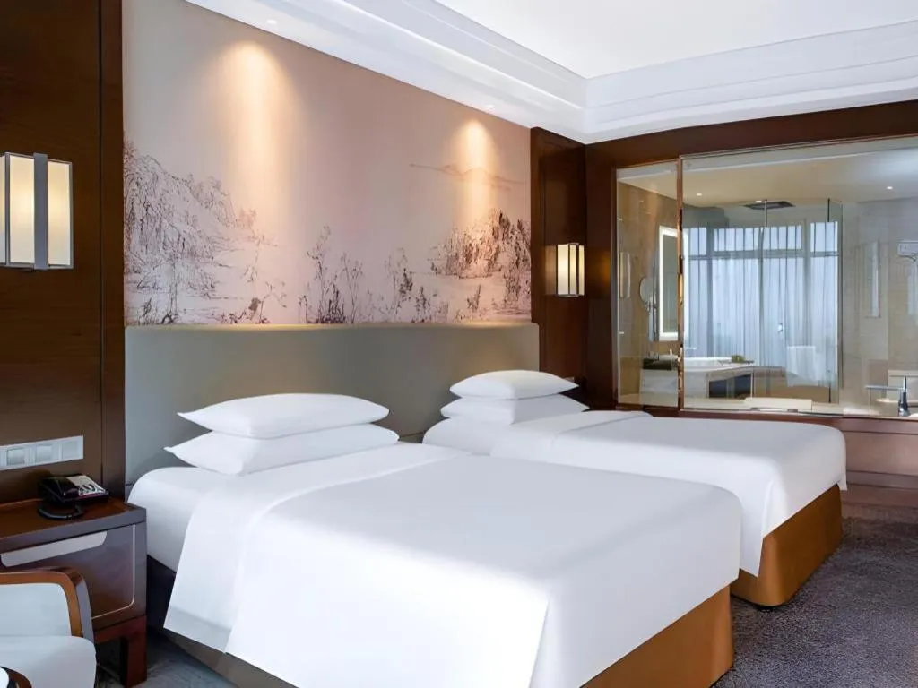 Bed in New Century Grand Hotel Hangzhou Fuyang Dongfangmao