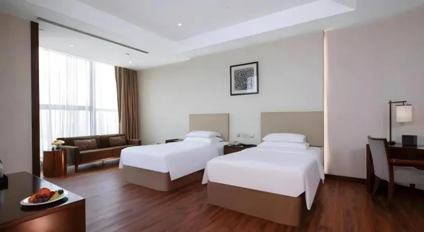Bed in New Century Grand Hotel Hangzhou Fuyang Dongfangmao