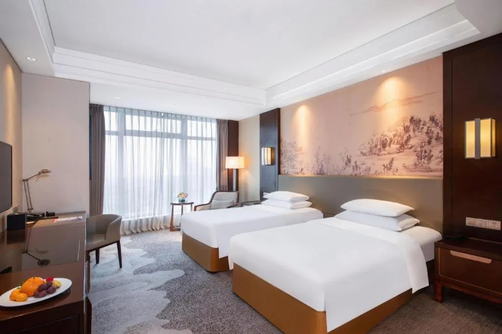 Bed in New Century Grand Hotel Hangzhou Fuyang Dongfangmao
