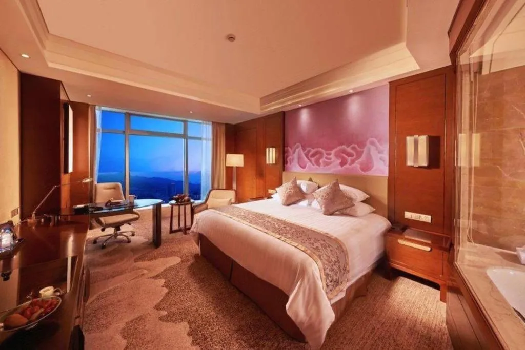 Bed in New Century Grand Hotel Hangzhou Fuyang Dongfangmao