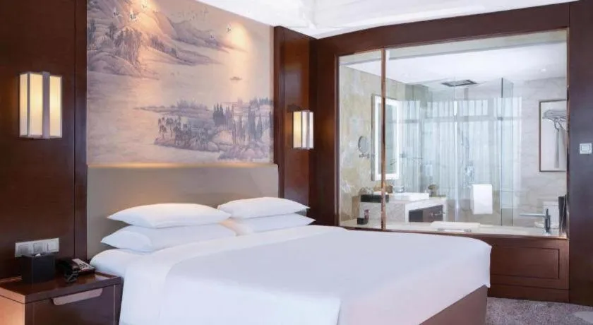 Bed in New Century Grand Hotel Hangzhou Fuyang Dongfangmao