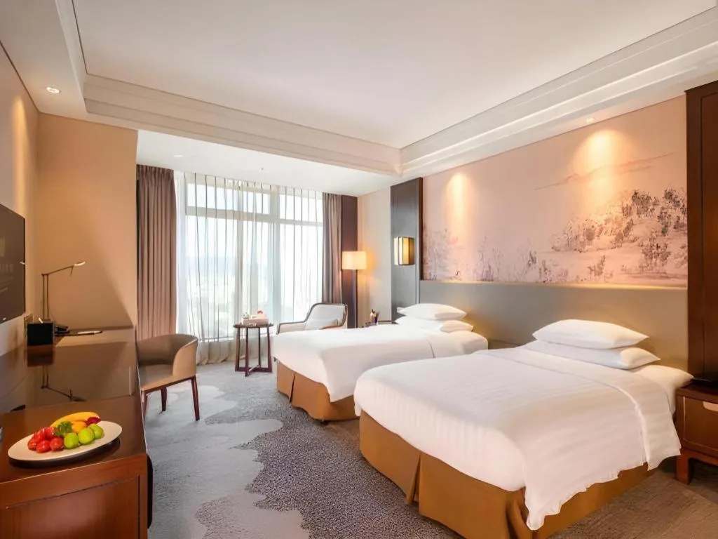 Bed in New Century Grand Hotel Hangzhou Fuyang Dongfangmao