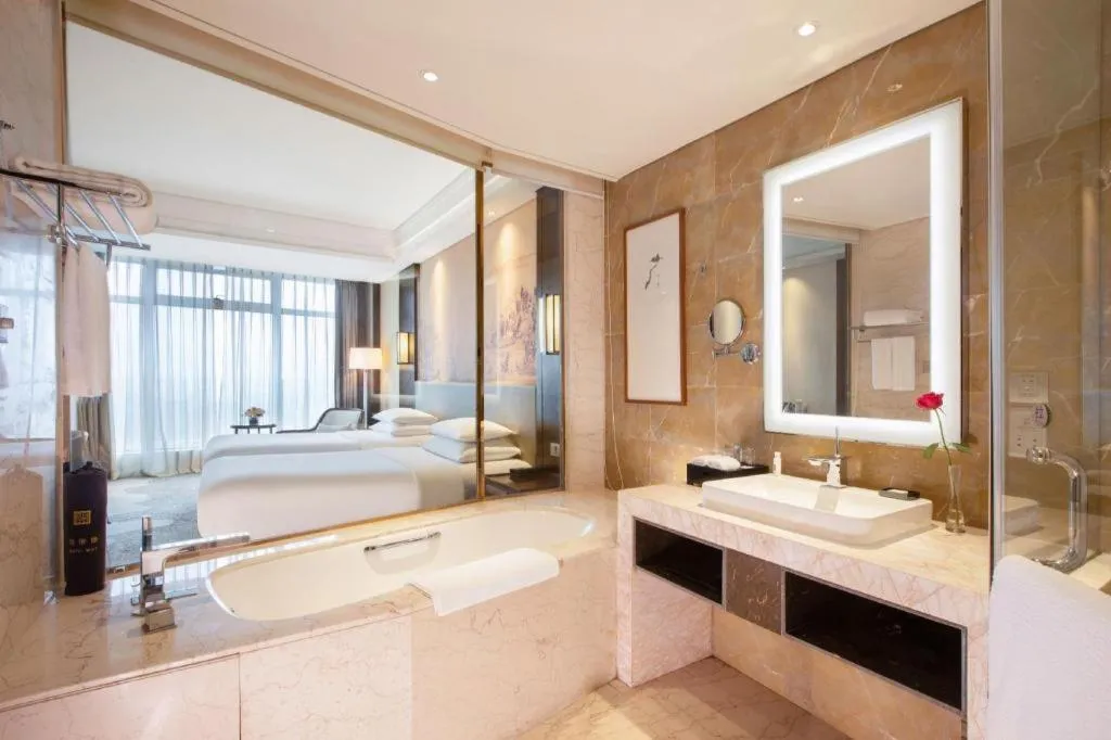 Bed in New Century Grand Hotel Hangzhou Fuyang Dongfangmao