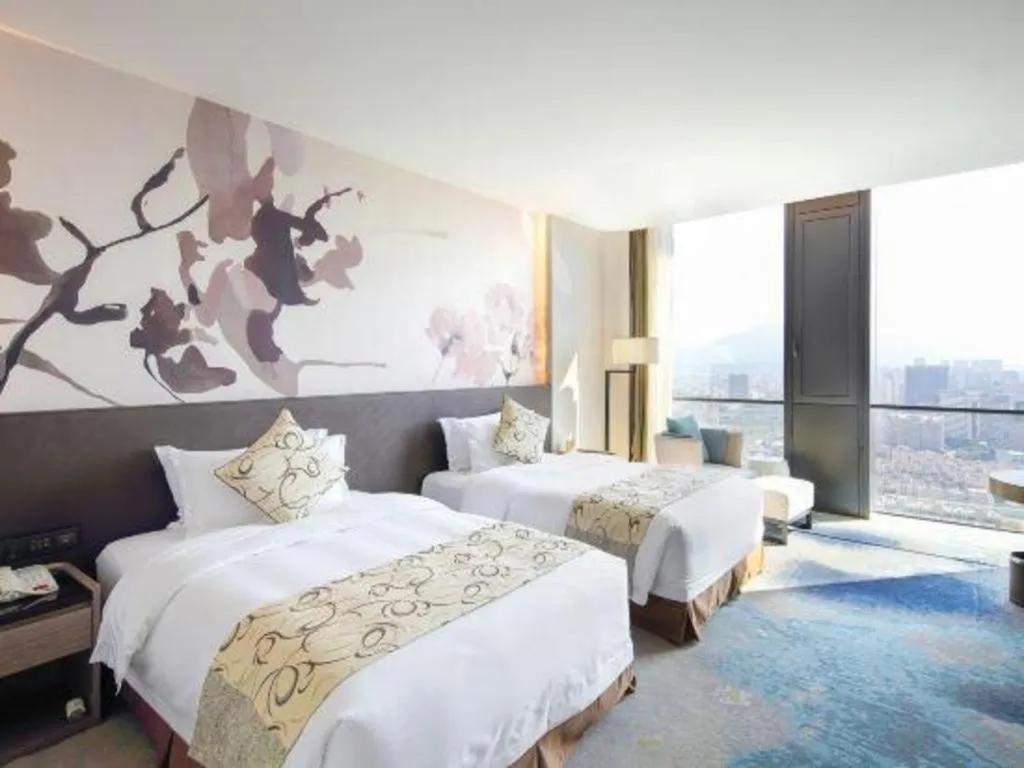 Bed in LONGYAN JINGHUA FLIPORT HOTEL