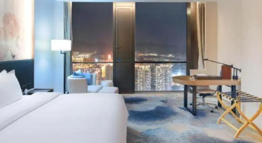 Bed in LONGYAN JINGHUA FLIPORT HOTEL