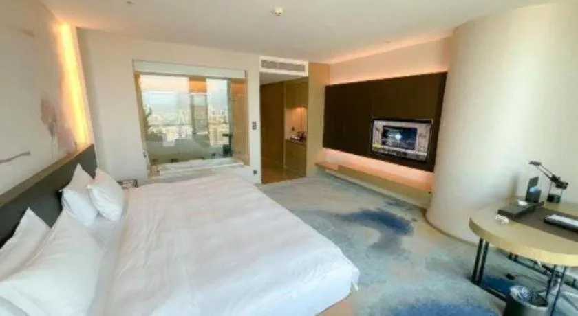 Bed in LONGYAN JINGHUA FLIPORT HOTEL