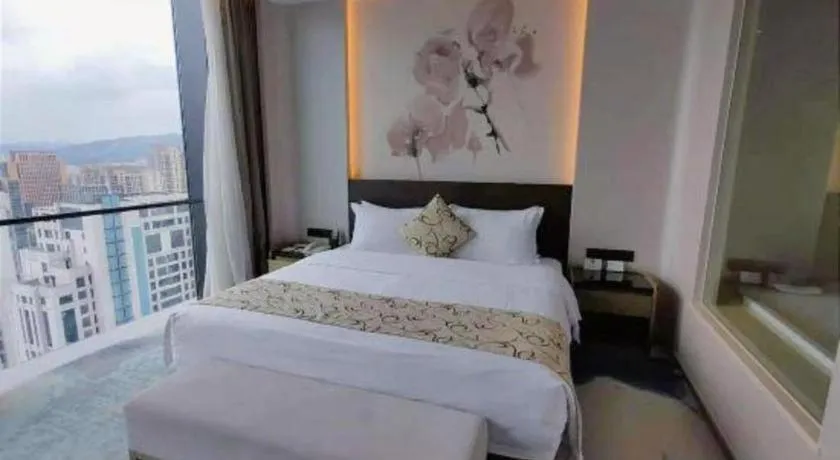 Bed in LONGYAN JINGHUA FLIPORT HOTEL