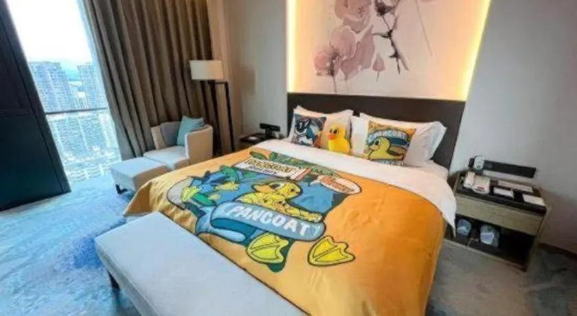 Bed in LONGYAN JINGHUA FLIPORT HOTEL