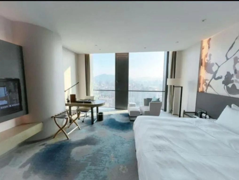 Bed in LONGYAN JINGHUA FLIPORT HOTEL