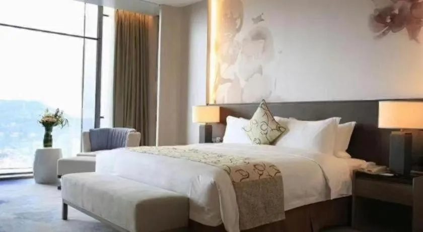 Bed in LONGYAN JINGHUA FLIPORT HOTEL