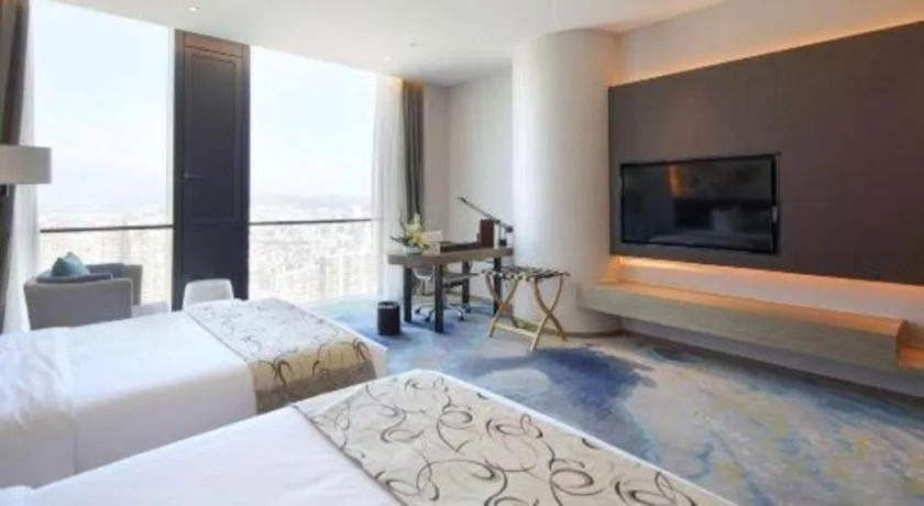 Bed in LONGYAN JINGHUA FLIPORT HOTEL