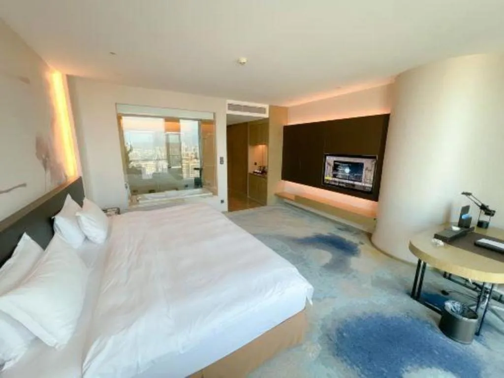 Bed in LONGYAN JINGHUA FLIPORT HOTEL