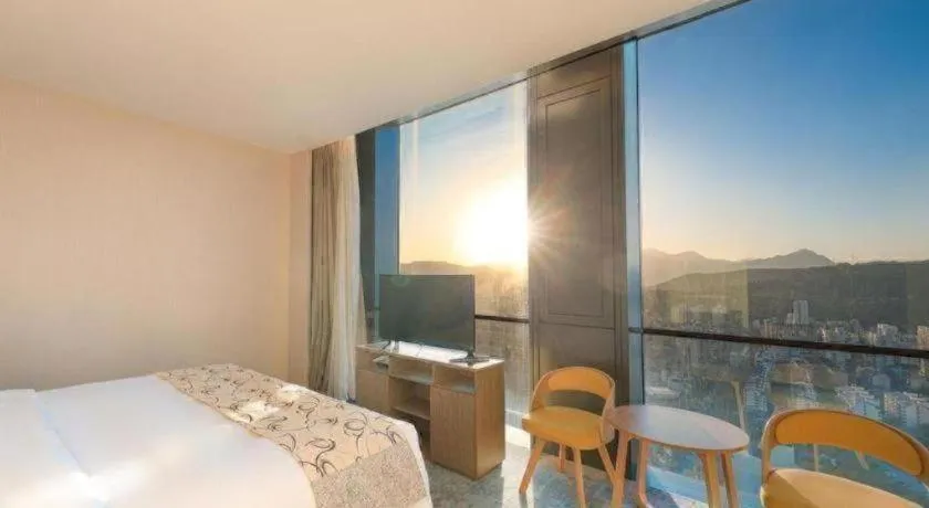 Bed in LONGYAN JINGHUA FLIPORT HOTEL