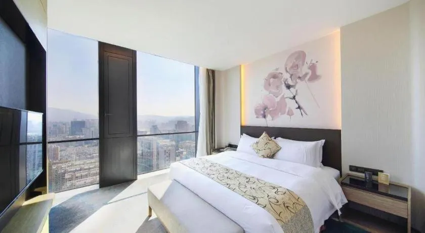 Bed in LONGYAN JINGHUA FLIPORT HOTEL