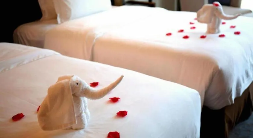 Bed in LONGYAN JINGHUA FLIPORT HOTEL