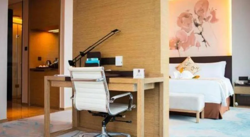 Bed in LONGYAN JINGHUA FLIPORT HOTEL