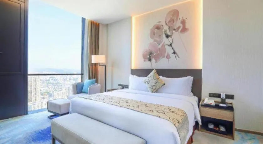 Bed in LONGYAN JINGHUA FLIPORT HOTEL