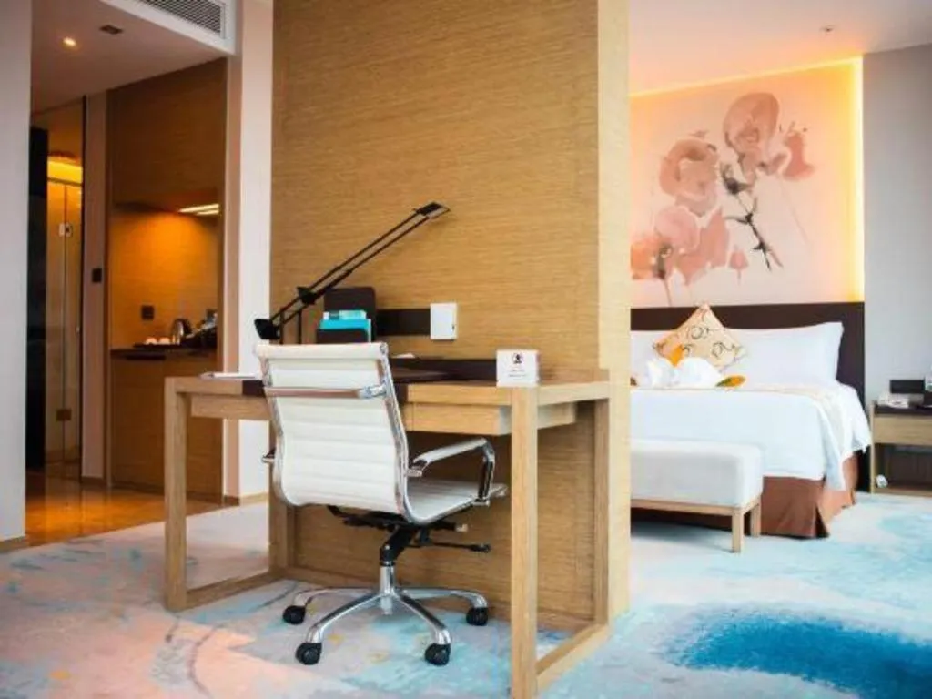 Bed in LONGYAN JINGHUA FLIPORT HOTEL