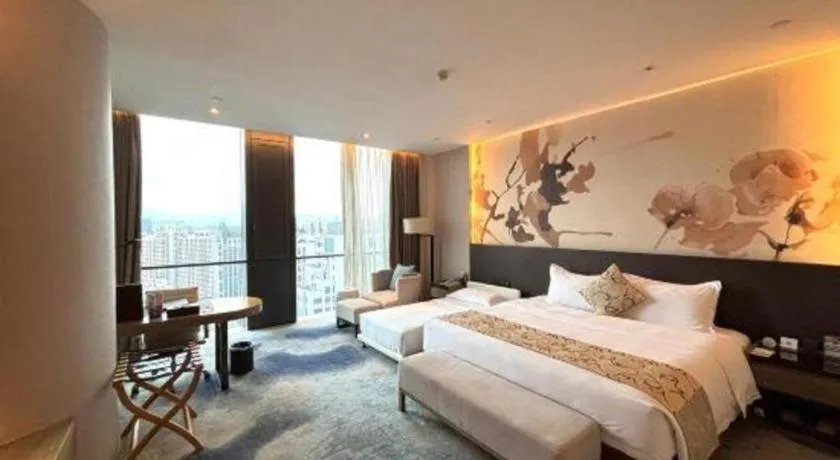 Bed in LONGYAN JINGHUA FLIPORT HOTEL