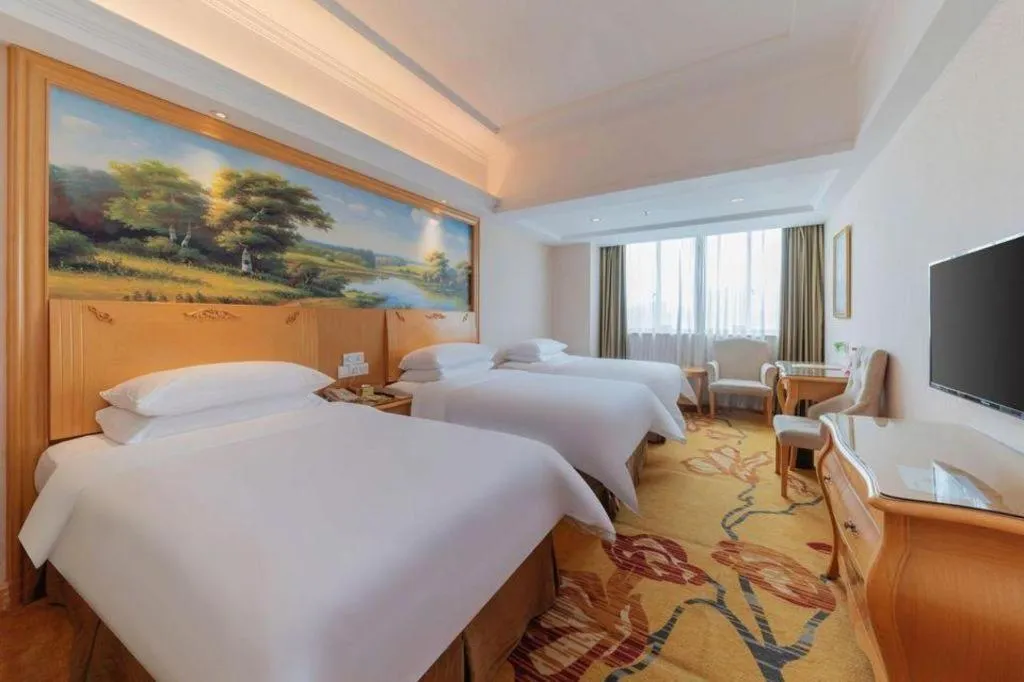 Bed in Vienna Hotel Guangdong Qingyuan Wanda Plaza Xincheng Beijiang