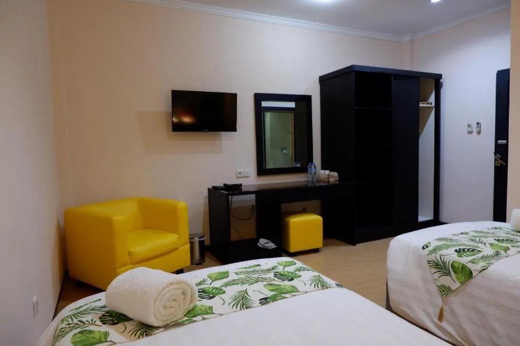 Bed in Tropical Point Hotel Syariah