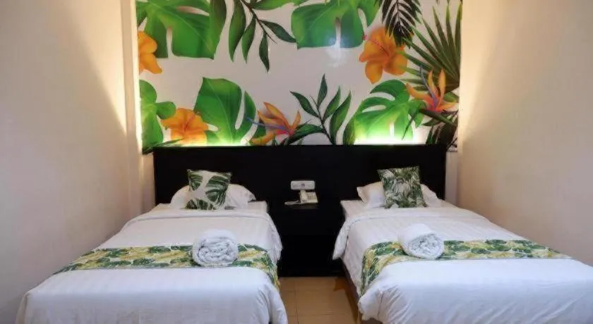 Bed in Tropical Point Hotel Syariah