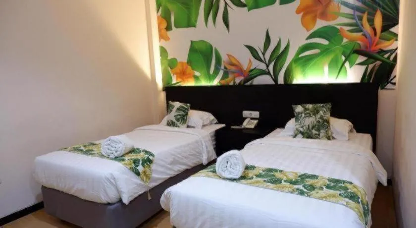 Bed in Tropical Point Hotel Syariah
