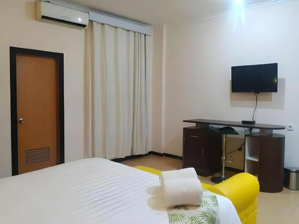 Bed in Tropical Point Hotel Syariah