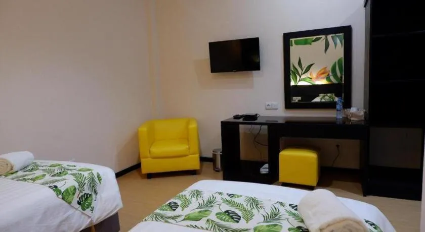 Bed in Tropical Point Hotel Syariah