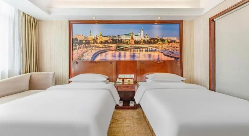 Bed in Vienna International Hotel Guangzhou Tianhe Olympic Stadium Dongpu
