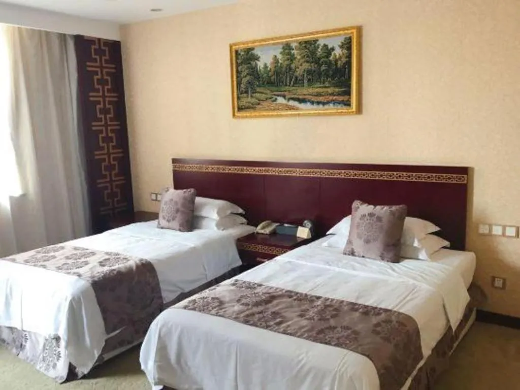 Bed in Bliss International Hotel Weihai