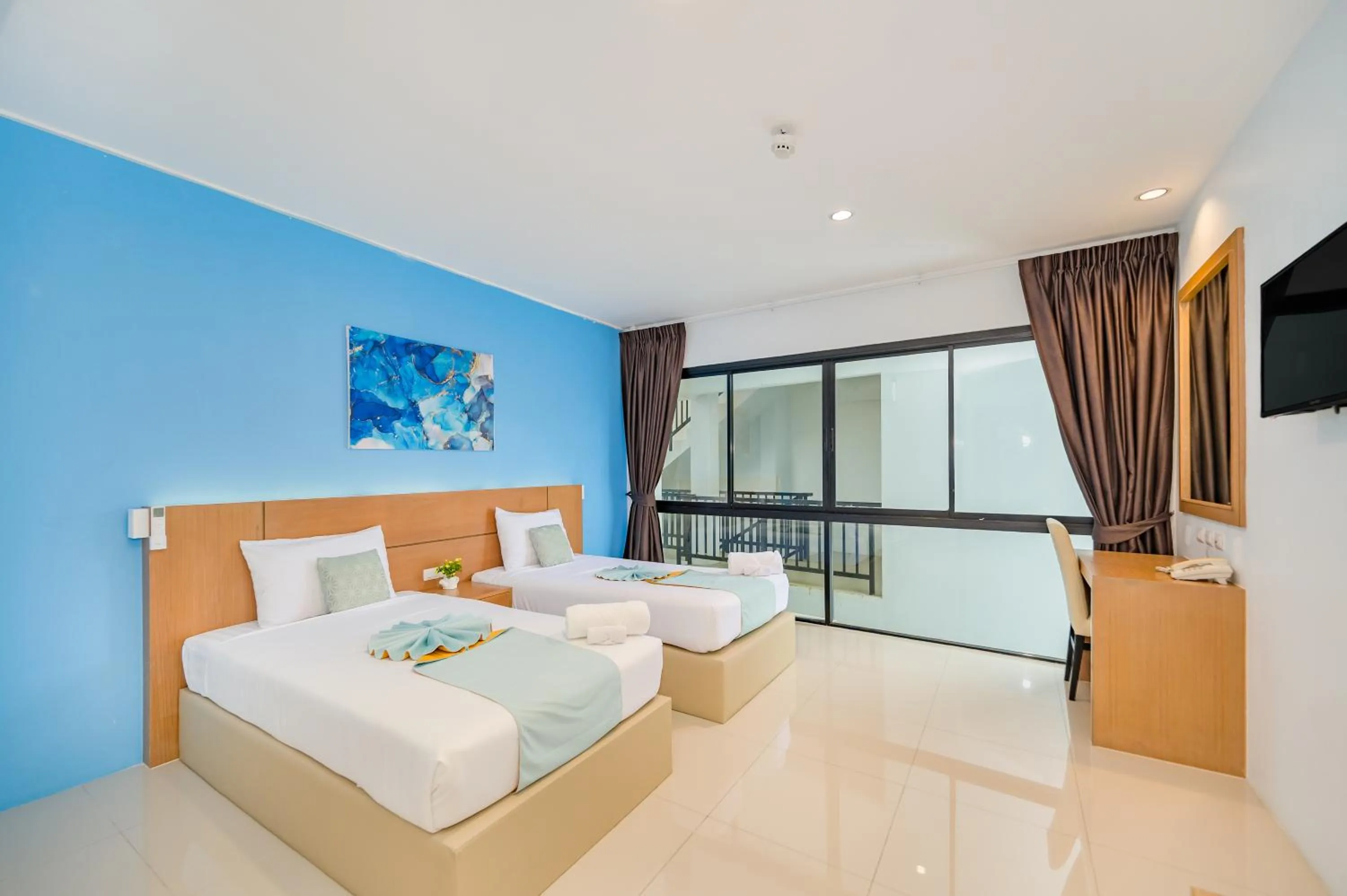 Bed in De Blue Sea Rawai Hotel