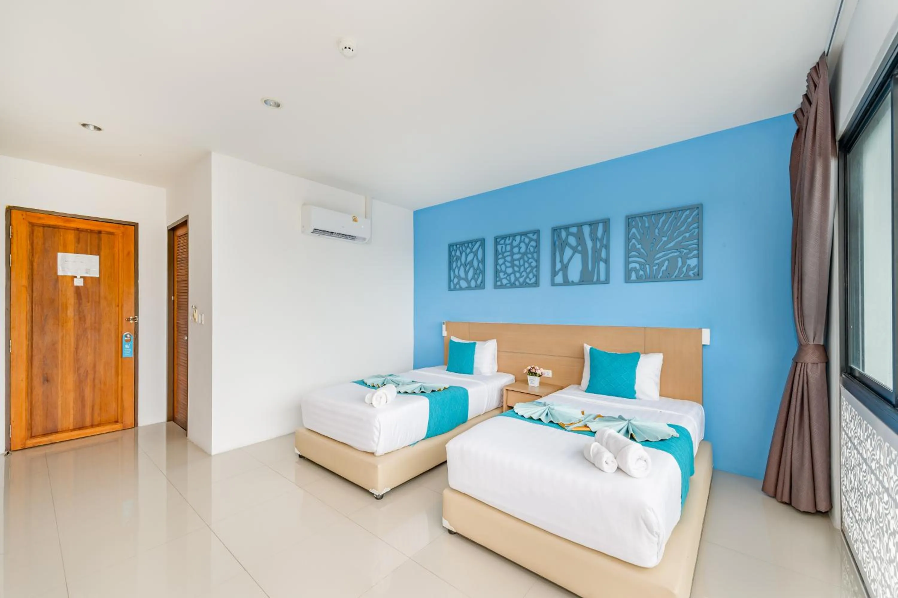 Bed in De Blue Sea Rawai Hotel