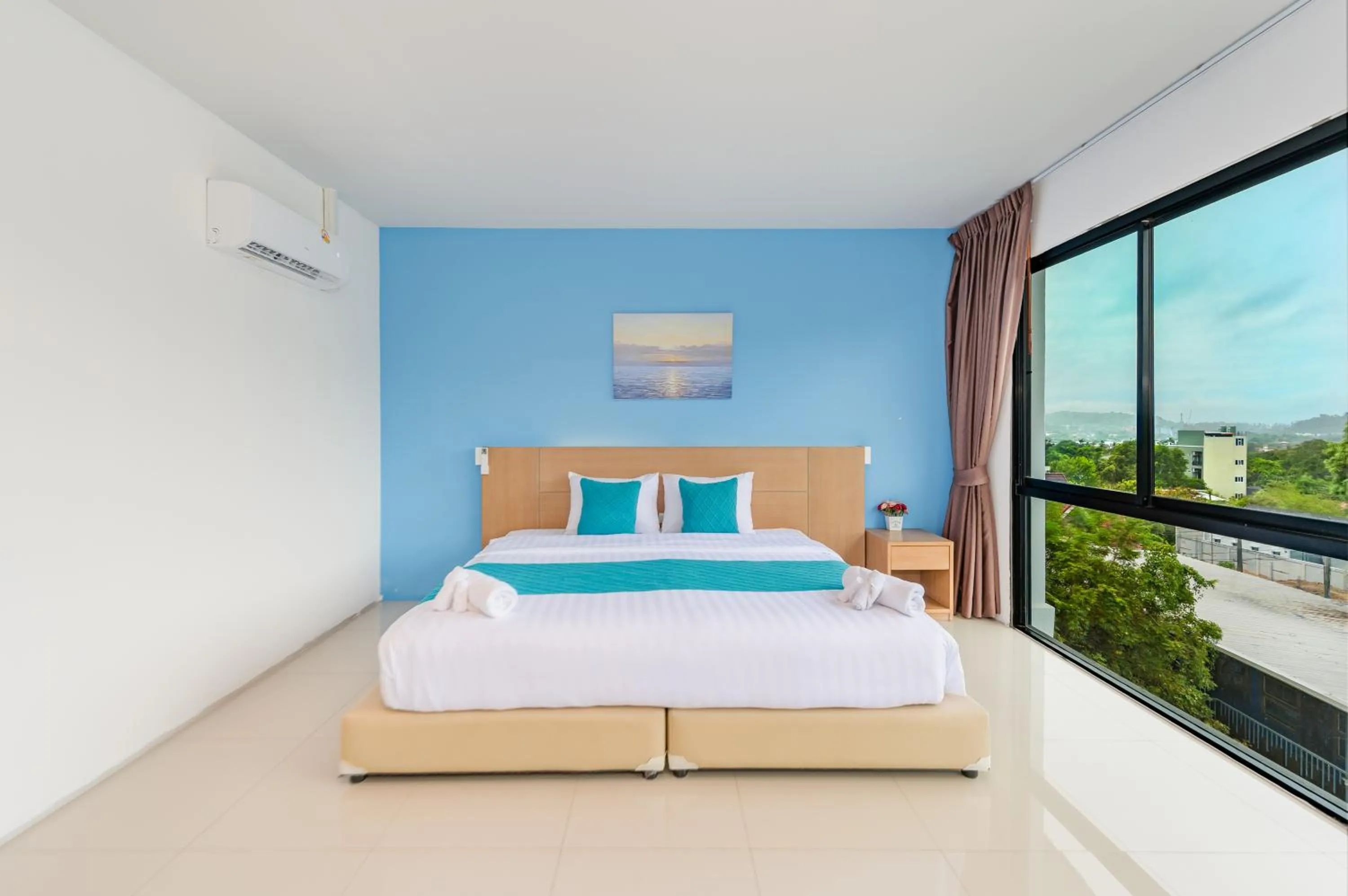 Bed in De Blue Sea Rawai Hotel