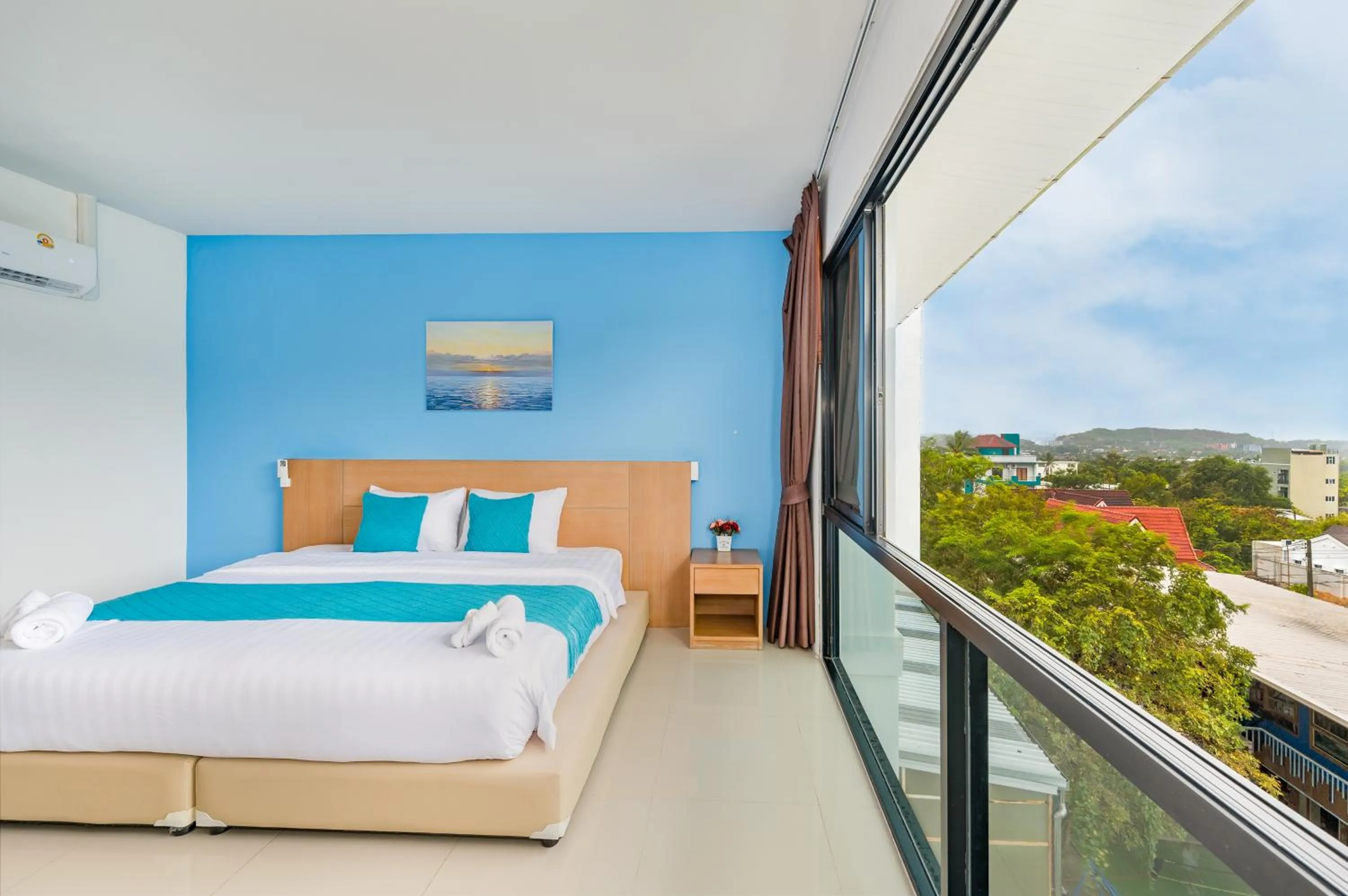 Bed in De Blue Sea Rawai Hotel