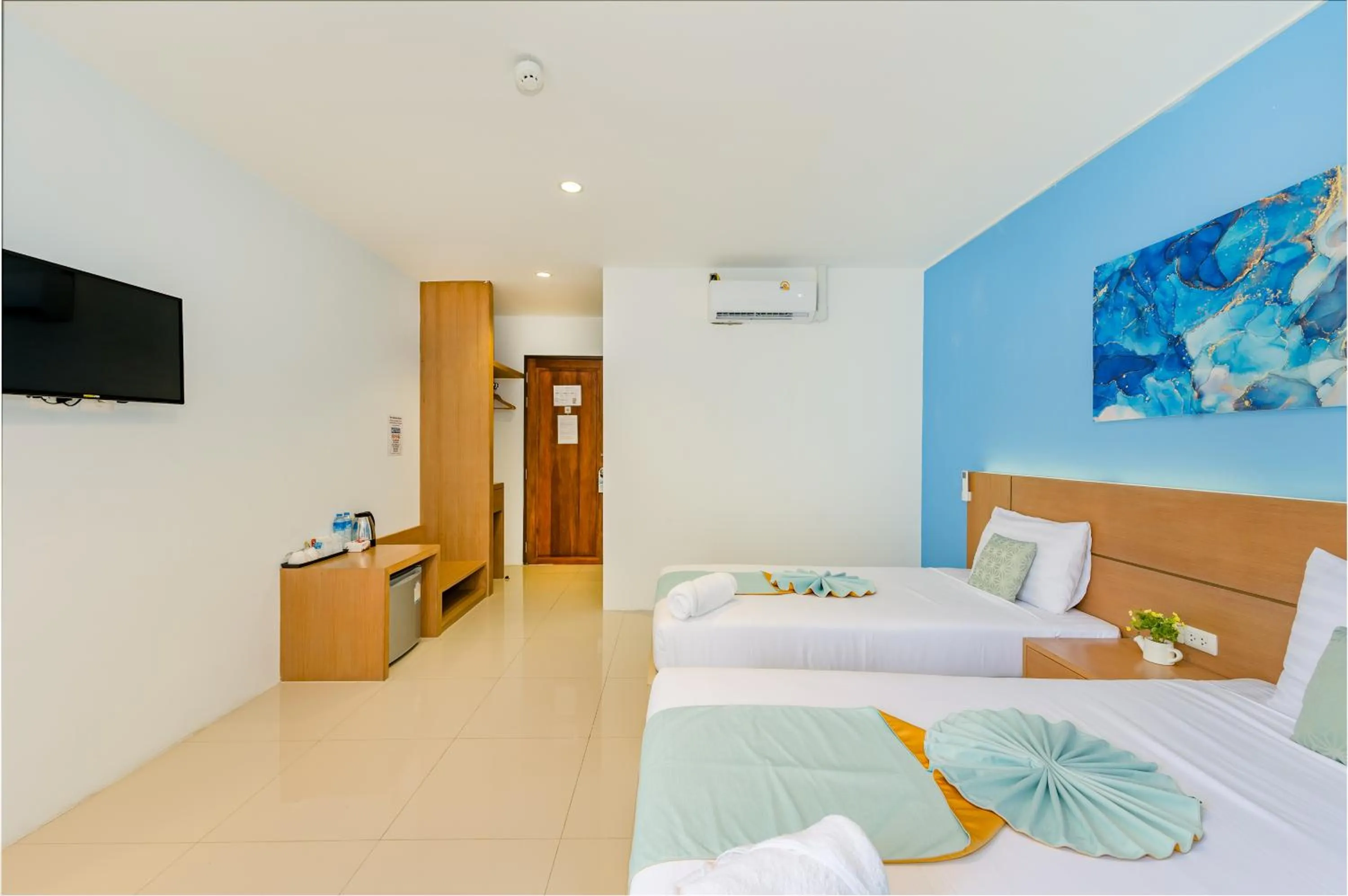 Bed in De Blue Sea Rawai Hotel