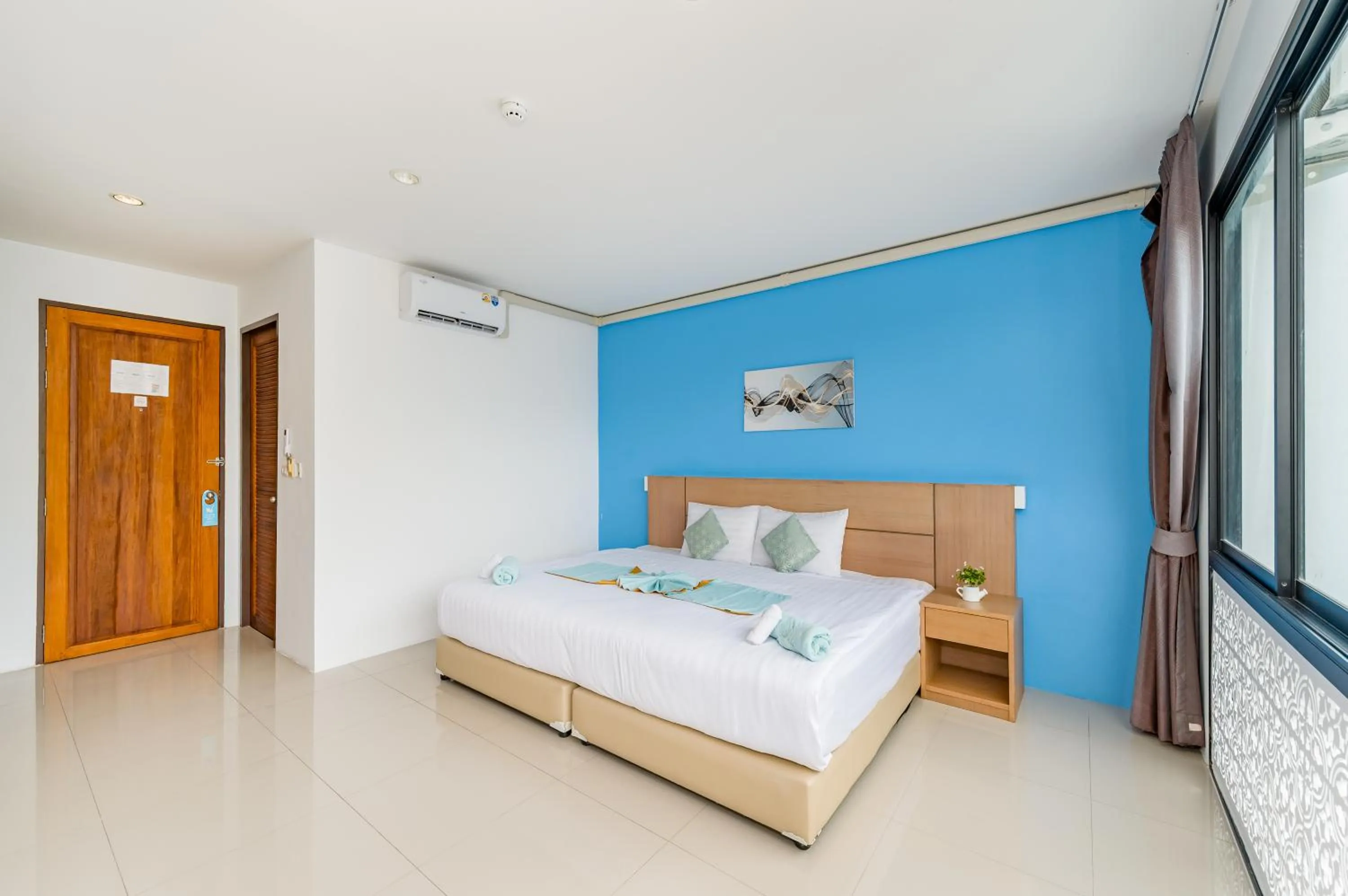 Bed in De Blue Sea Rawai Hotel